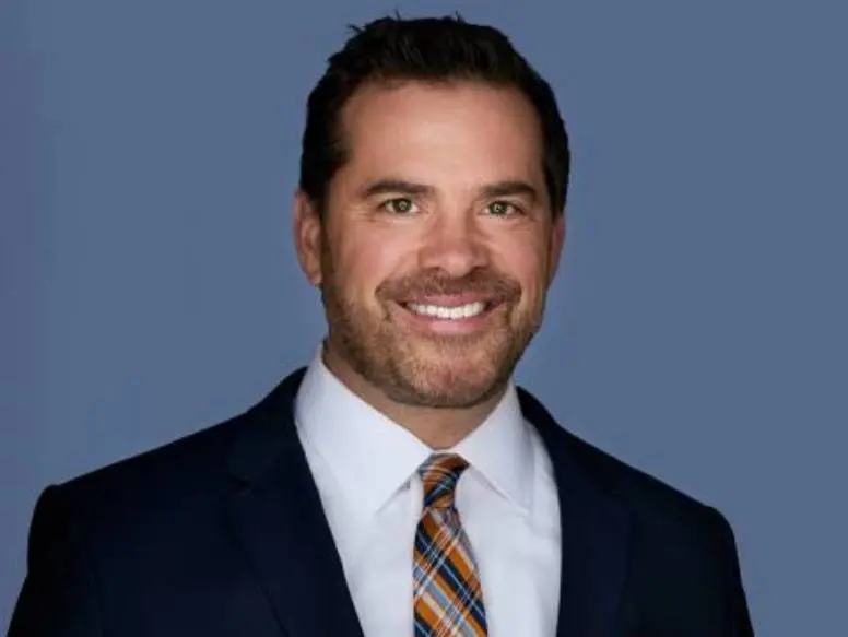Smiling man in a suit and tie.